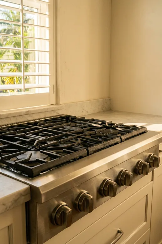 Viking range burner with the grate lifted and ports exposed